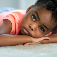 African American little girl with a sad face.