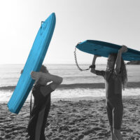 boy and girl with surfboards
