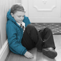 child slumped at door refusing school